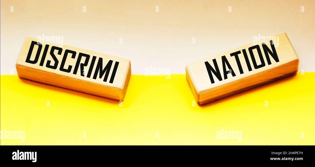 Discrimination is a wooden block word with letters, Human Rights. Prejudice and Inequality. Racism. Gender discrimination concept Stock Photo