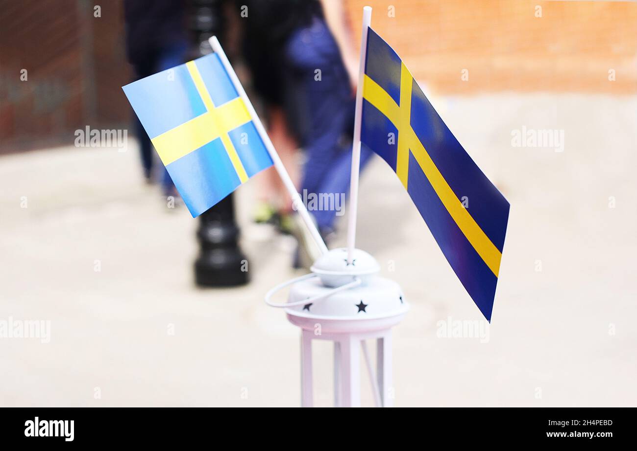 Close-up of Swedish flags in a miniature white lamp. Stock Photo