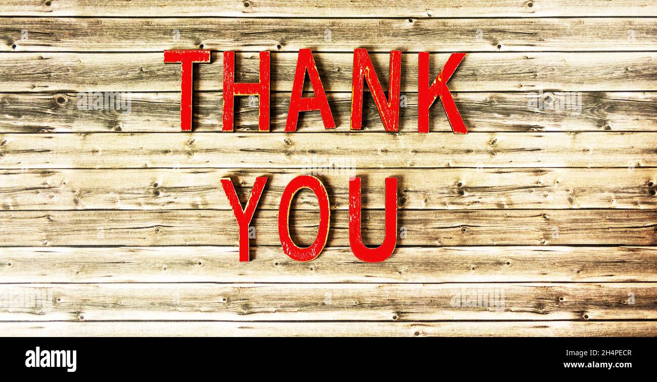 On a wooden background, red letters with the word THANK YOU Stock Photo