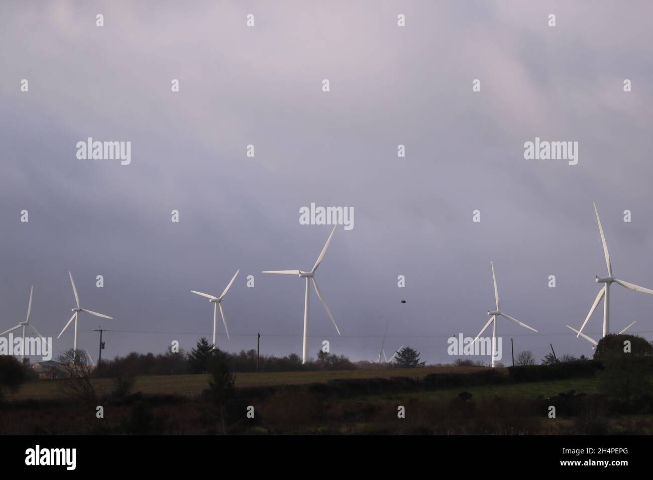 Wind turbines on farmland in Co. Derry, Northern Ireland.  To reduce carbon emissions the UK and governments are using wind and solar energy. Stock Photo