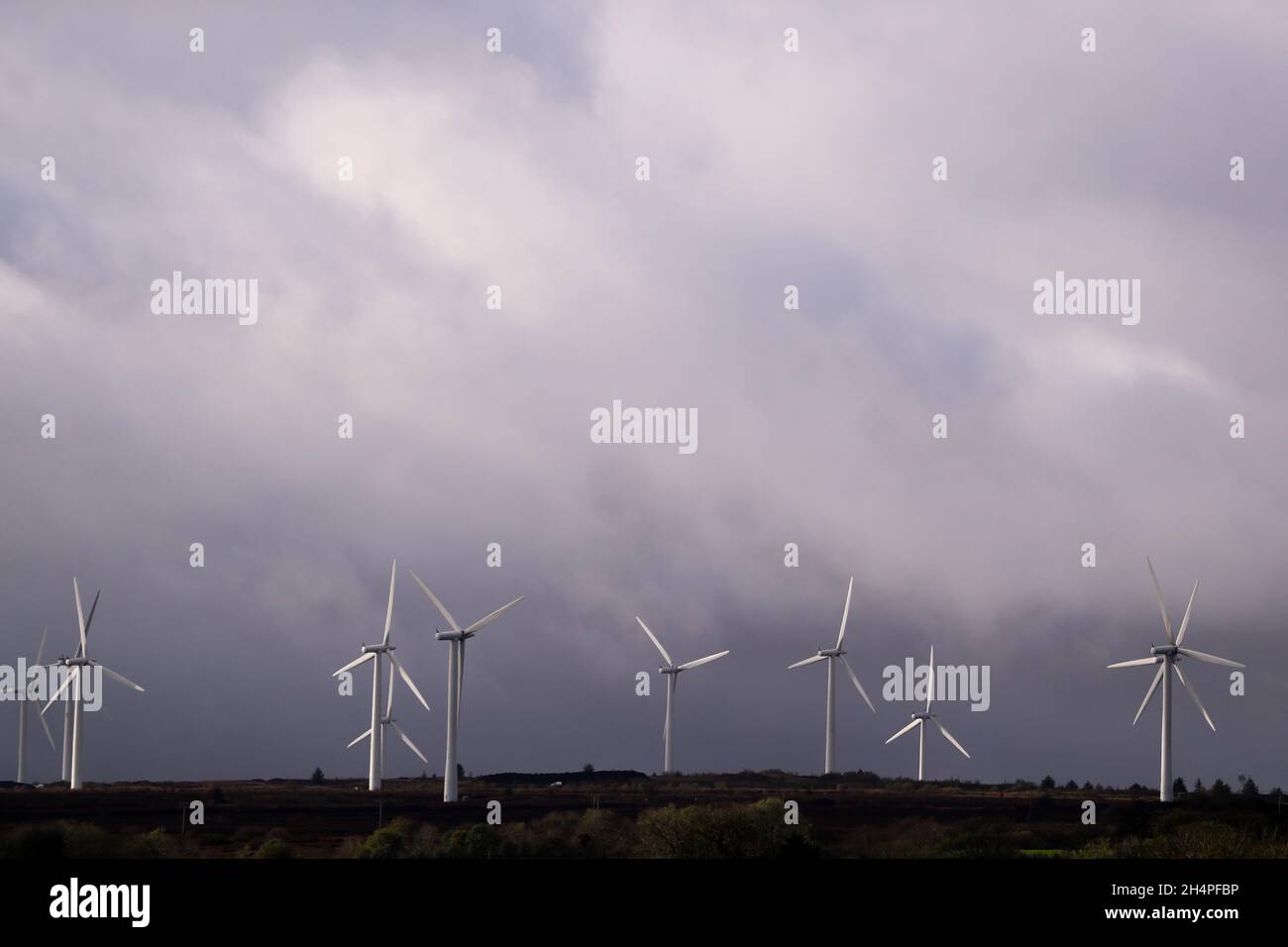Wind turbines on farmland in Co. Derry, Northern Ireland.  To reduce carbon emissions the UK and governments are using wind and solar energy. Stock Photo