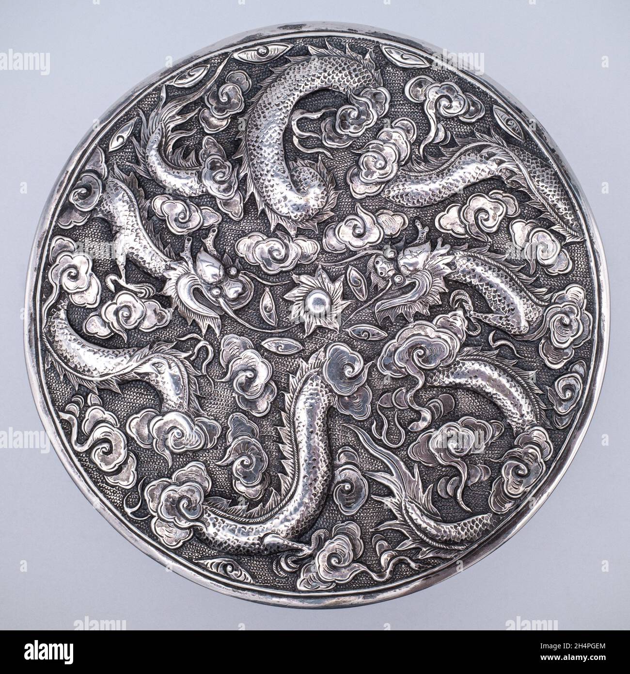 Antique Chinese Silver Box Decorated With Dragons Chasing Flaming Pearls. Marked He Zhen, late 19th century Stock Photo