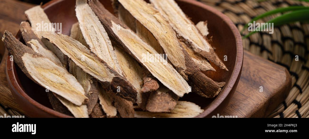 Close up of Chinese traditional herbal medicine Astragalus root on wooden table background. Stock Photo