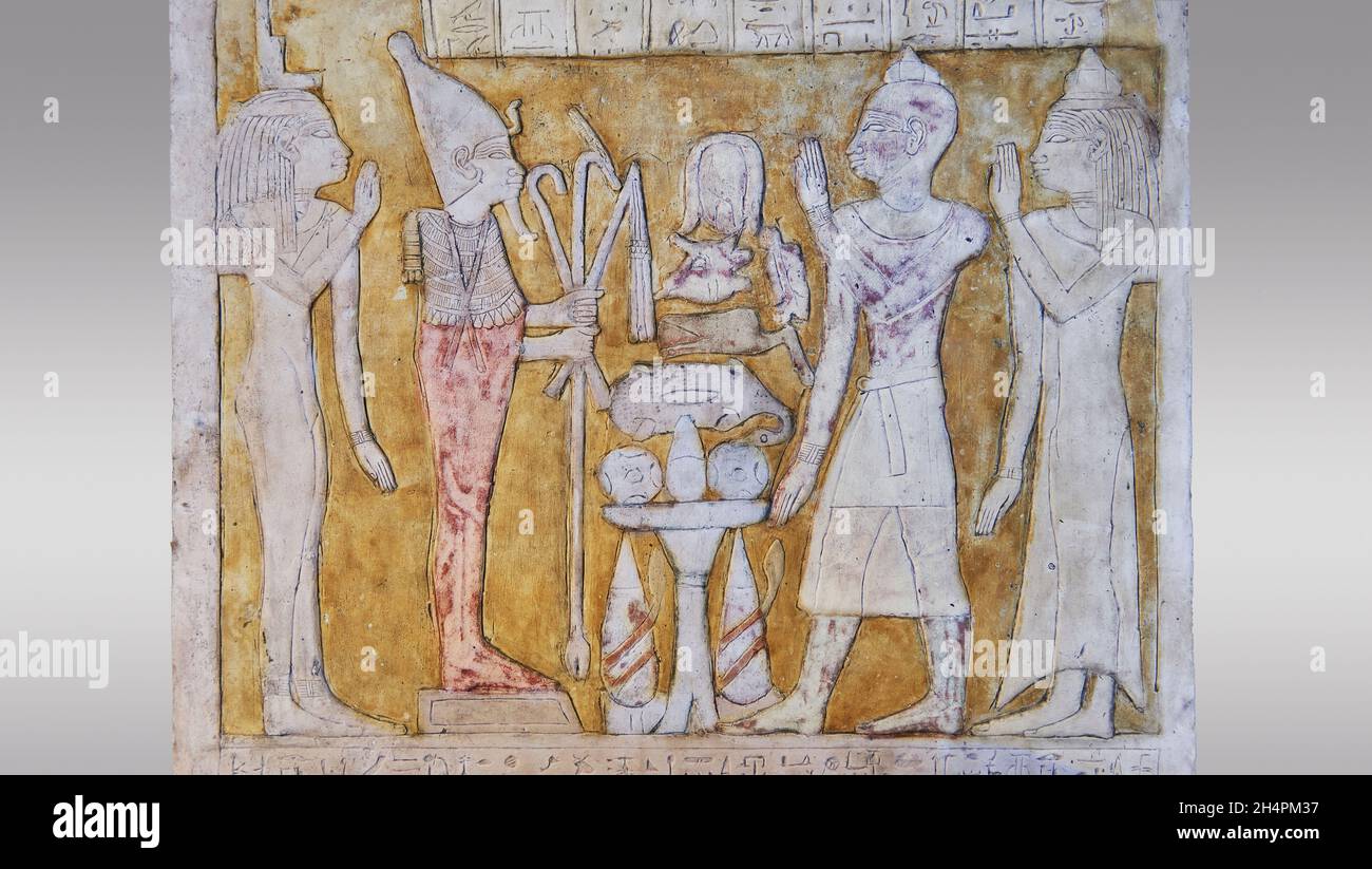 Ancient Egyptian stele of priest Khonsouirdis and wife worshiping Osiris and Iris, 690-595 BC, 25th dynasty, El-araga el-Madfourna Thebes. Louvre Muse Stock Photo