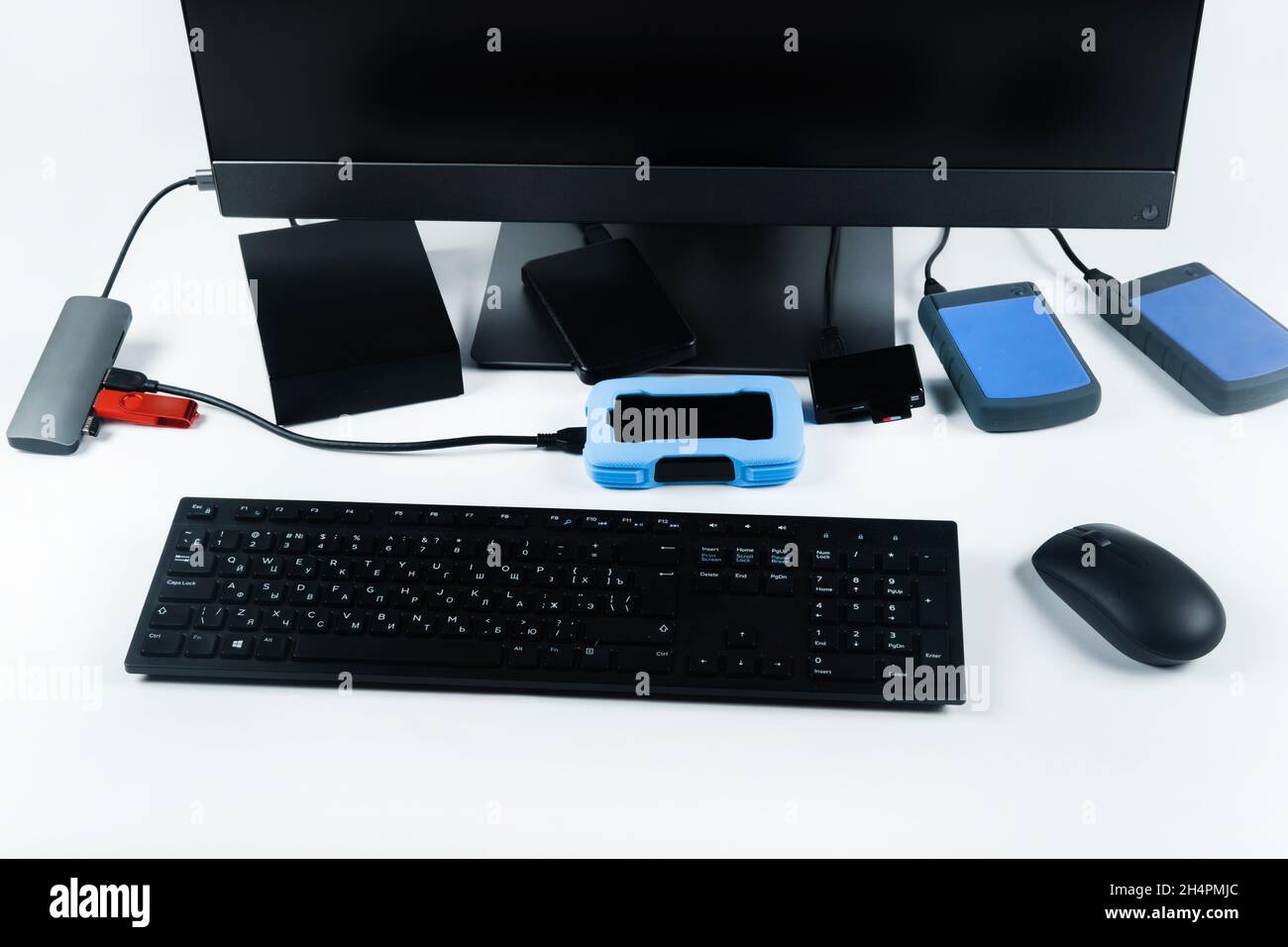 Multiple external hard drives connected to a monoblock on a white