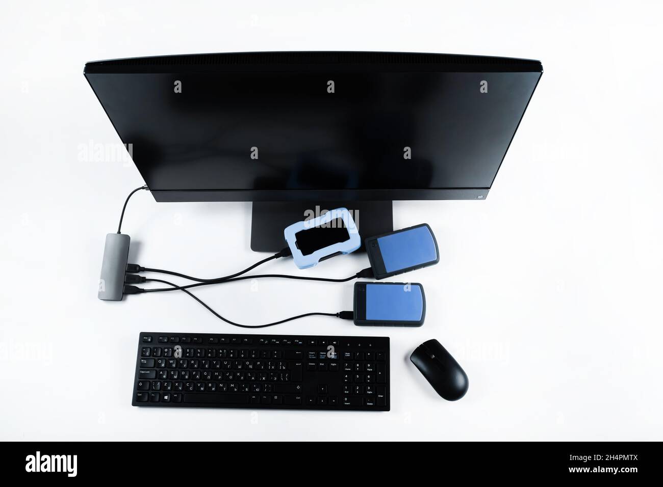 Multiple external hard drives connected to a monoblock on a white
