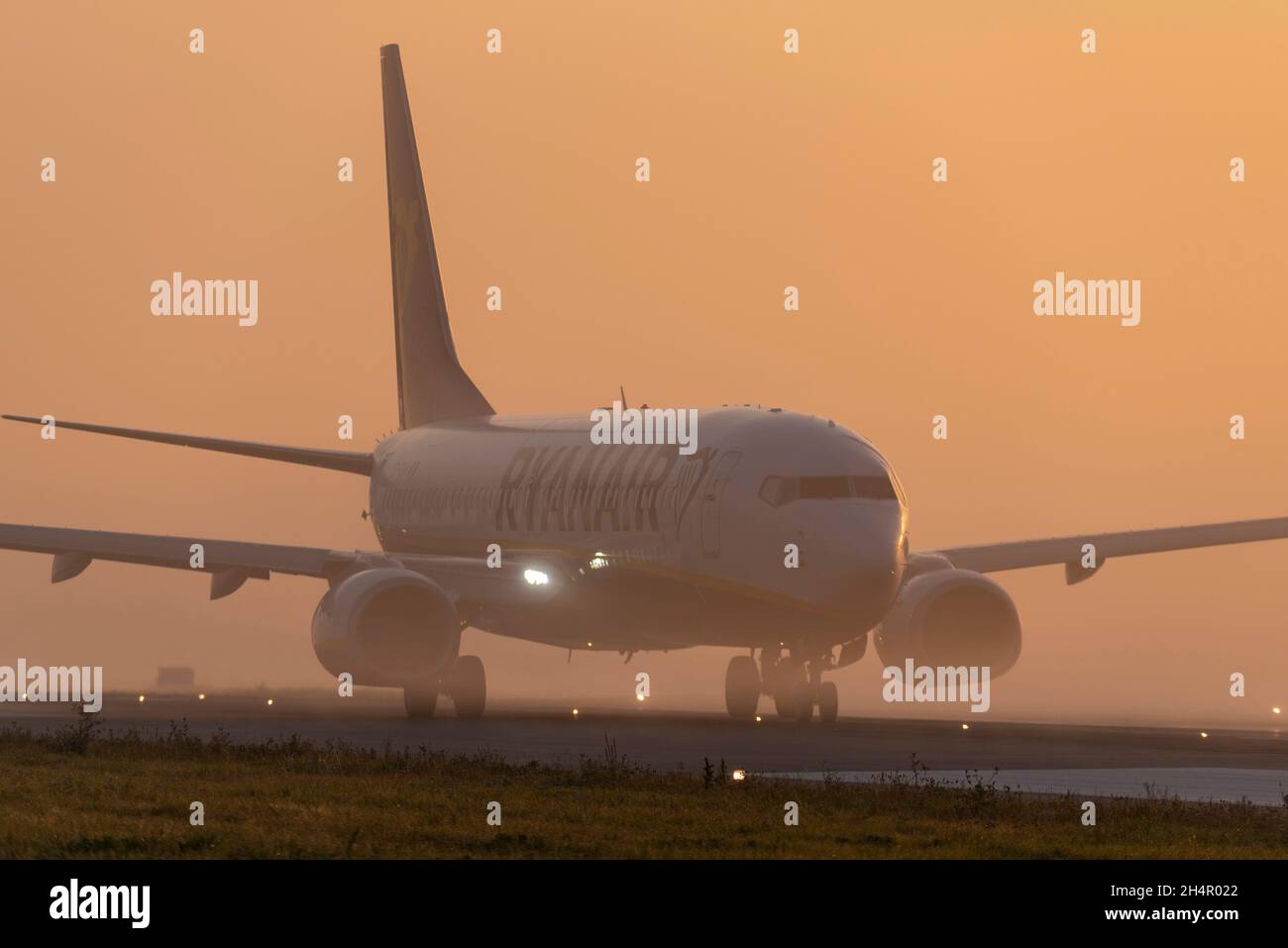 Ryanair Boeing 737 airliner jet plane taxiing out for an early morning flight at London Southend Airport, Essex, UK, in fog and mist at sunrise Stock Photo