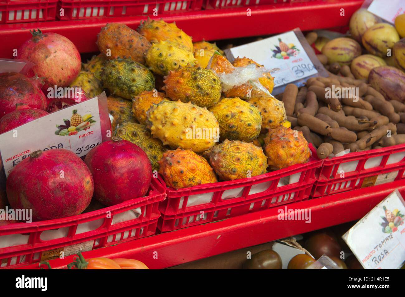 Closeup of a shelf in a greengrocer where there are horned melons