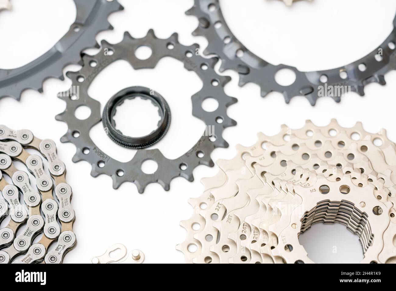 Gears, sprockets and chain of a mountain sports bike on a white