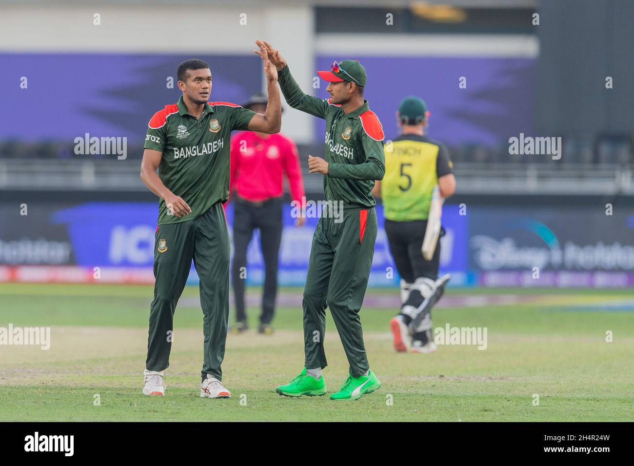 Dubai, UAE, 4th Nov, 2021. Taskin Ahmed of Bangladesh (left) celebrates the wicket of Aaron Finch, captain of Australia during the ICC Mens T20 World Cup match between Australia and Bangladesh at Dubai International Cricket Stadium, Dubai, UAE on 04 November 2021. Photo by Grant Winter. Editorial use only, license required for commercial use. No use in betting, games or a single club/league/player publications. Credit: UK Sports Pics Ltd/Alamy Live News Stock Photo