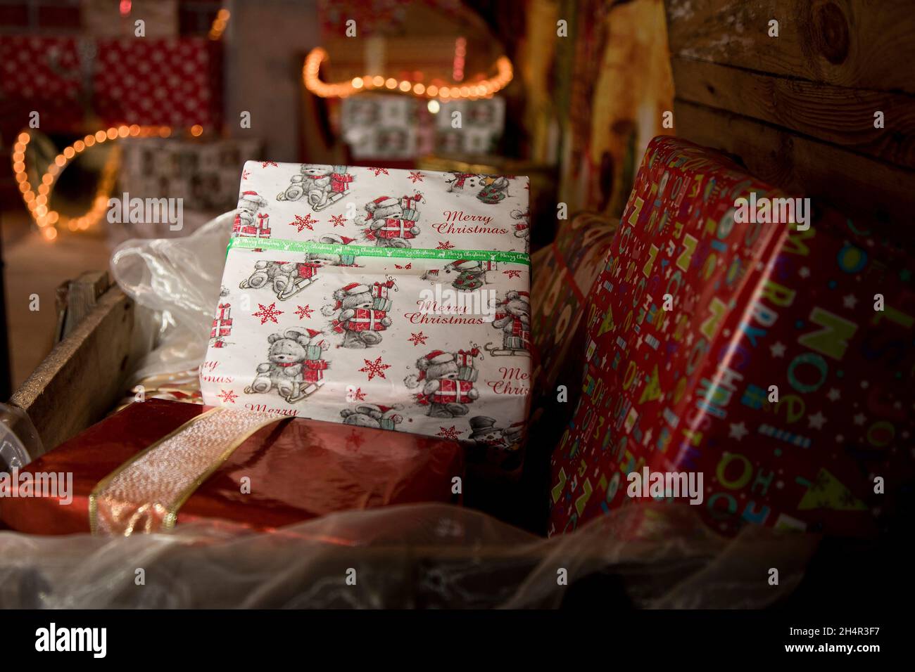 Assorted Christmas presents overflow from a wooden chest in 'Santa's Post Office' at Great Yarmouth. Stock Photo