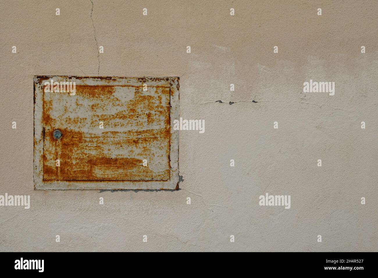 Close-up of the rusty box of a gas meter on the wall of an old building, Italy Stock Photo