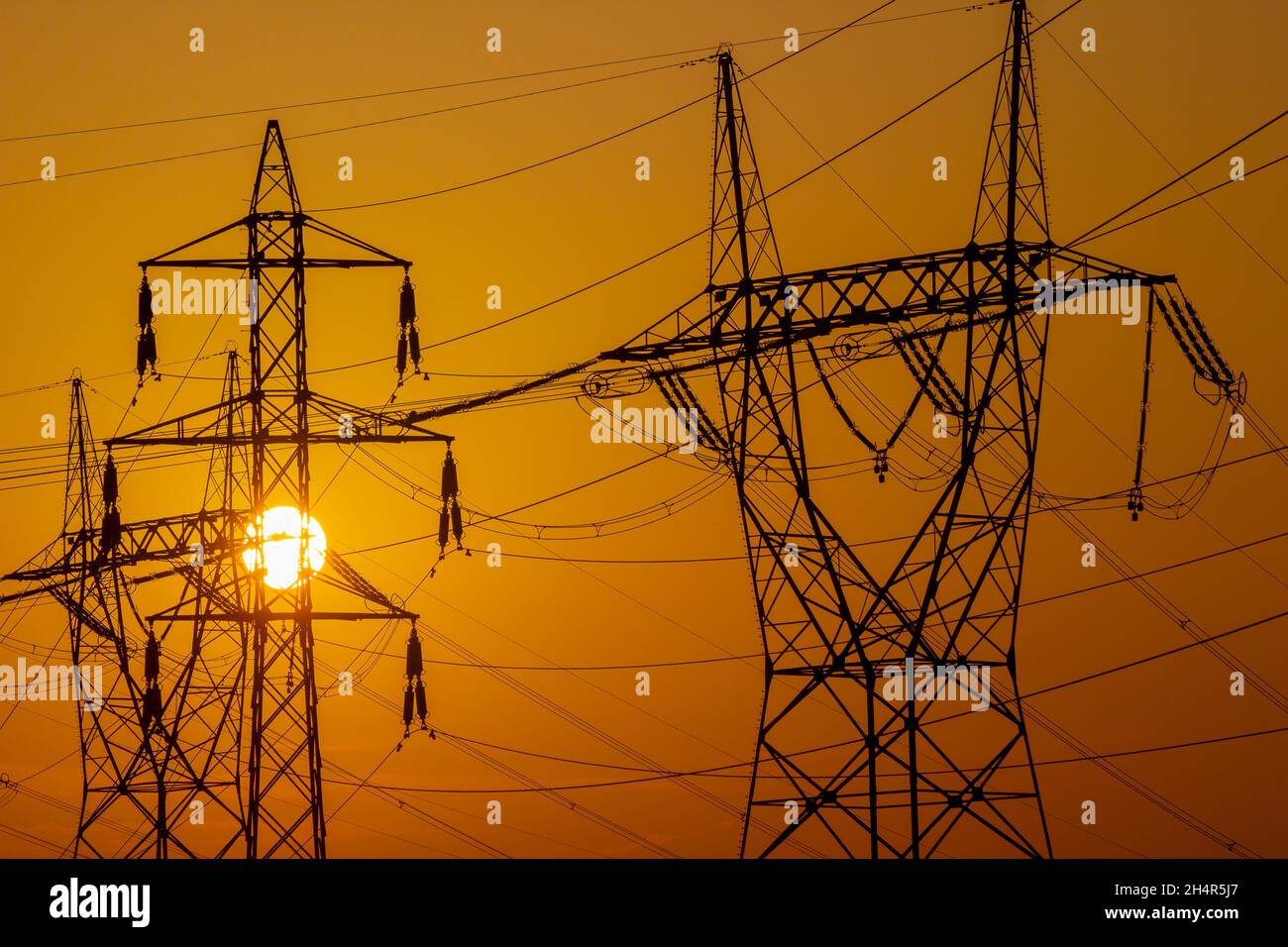 Transmission towers on sunset sky Stock Photo Alamy