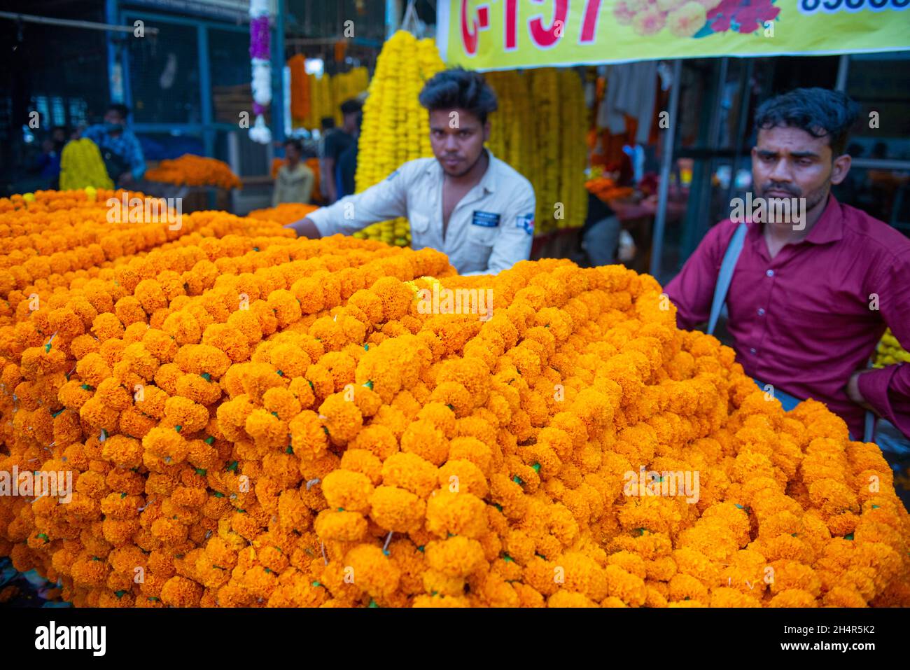A salesman seen selling marigold garland in a wholesale flower market