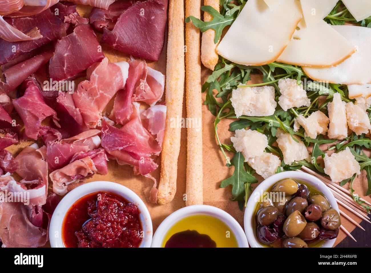 Sheffield, 29 Jan 2018 – a delicious cold platter of mixed dried meats and cheeses with bread olives and salad rocket at Veeno Stock Photo