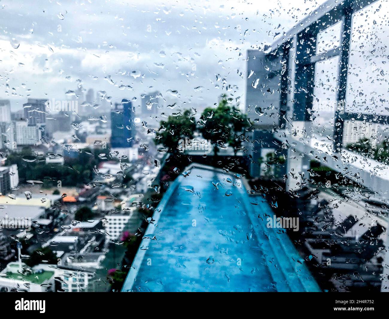 city through windows in raindrops Stock Photo