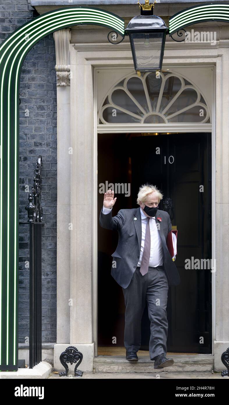 British Prime Minister Boris Johnson leaving 10 Downing Street for Prime Minister's Questions, 2nd November 2021. Green lights around the doorway for Stock Photo