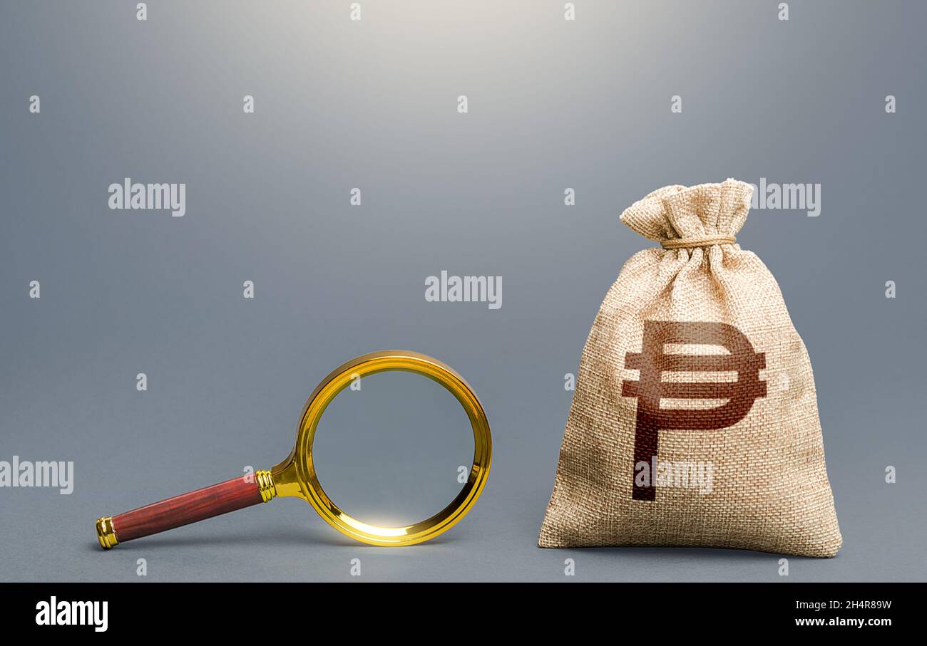 Philippine peso money bag and magnifying glass. Financial audit. Search for funding. Capital origins, legality of funds. Monitoring and accounting. Bu Stock Photo