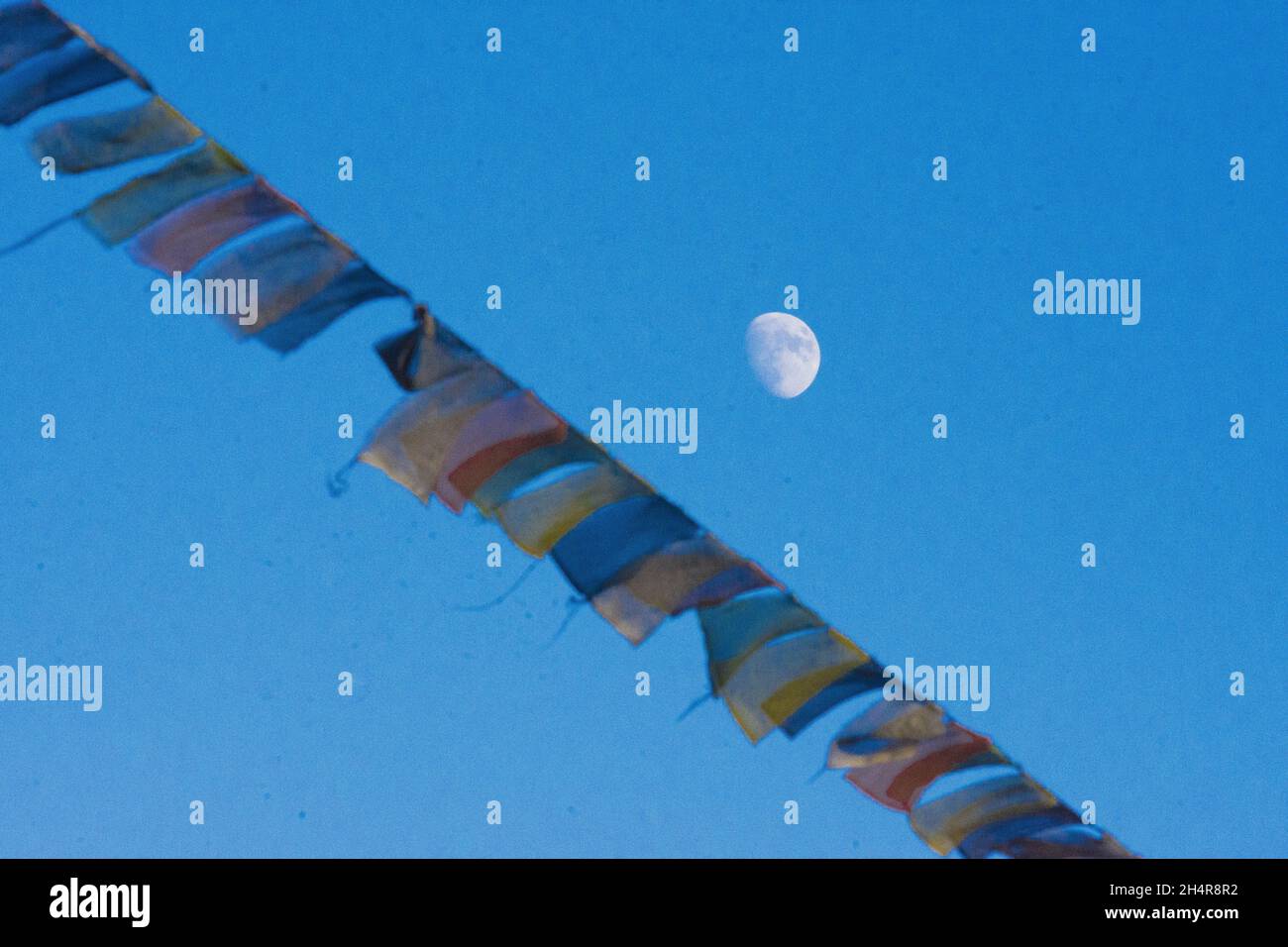 tibetan flags waving in the wind under the moon Stock Photo