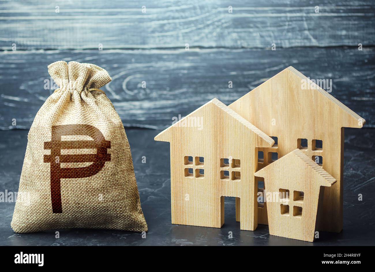 Philippine peso money bag and figurines of residential buildings