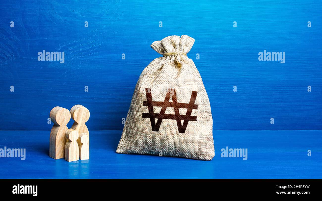 Family figurines and south korean won money bag. Social policy, family budget. Investment in human capital. Medicine and demography. Income and expens Stock Photo