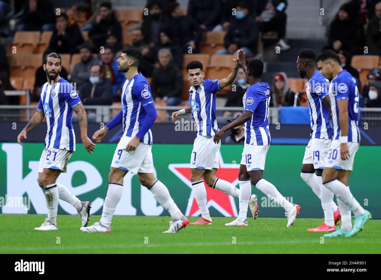 Luis Diaz of Fc Porto  celebrates after scoring his team's first goal with team mates during the Uefa Champions League Group B  match between Ac Milan and Fc Porto . Stock Photo