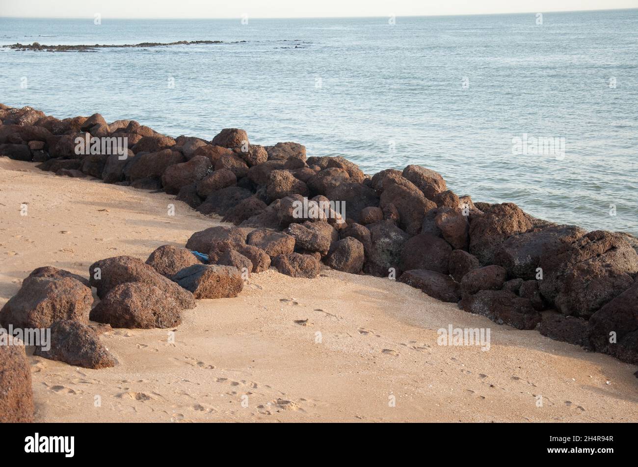 At the beach, Saly-Portudal, Petite Côte of Senegal, Senegal.  Beach, rocks; Atlantic Ocean Stock Photo