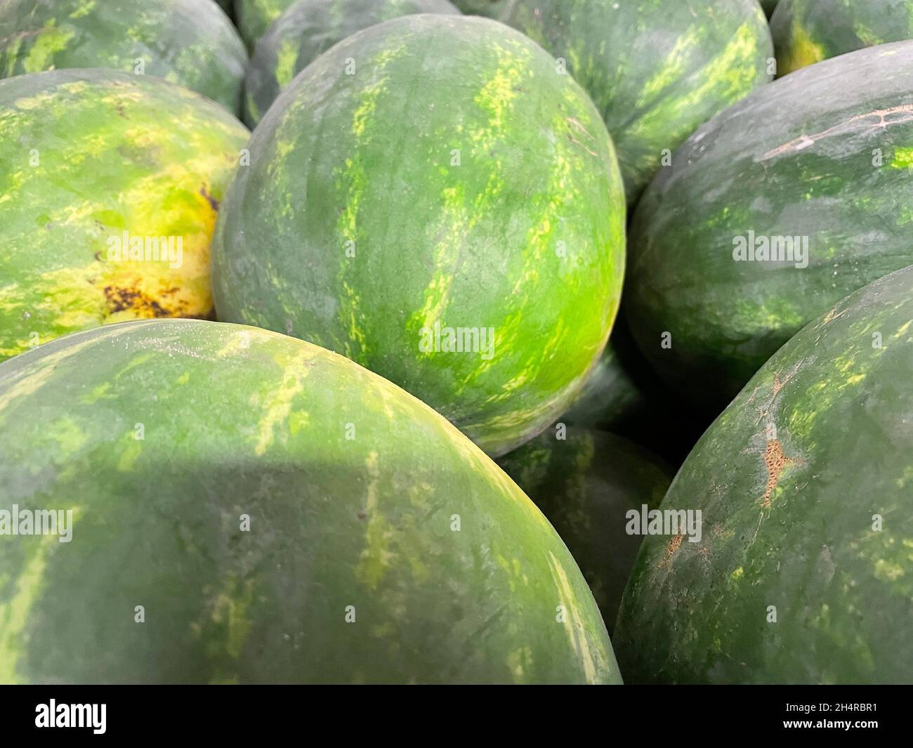 Watermelons in a pile on display in a retail grocery store in Stock Photo Alamy