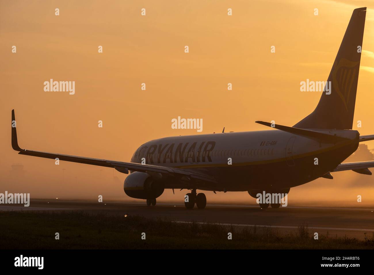 Ryanair Boeing 737 airliner jet plane taxiing out for an early morning flight at London Southend Airport, Essex, UK, in fog and mist at sunrise Stock Photo