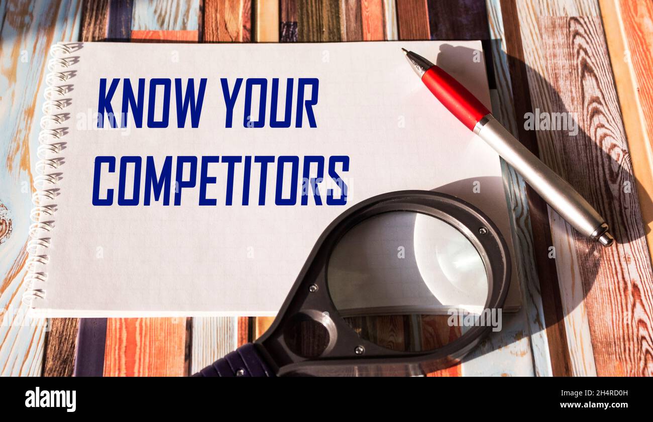 Text KNOW YOUR COMPETITORS business concept written on notepad. Stock Photo