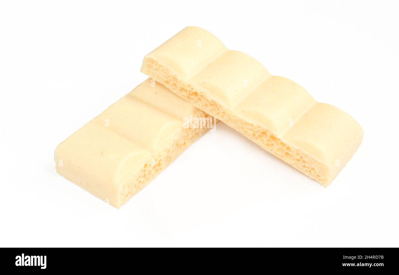 Two pieces of bubbly white milk chocolate isolated on white background Stock Photo