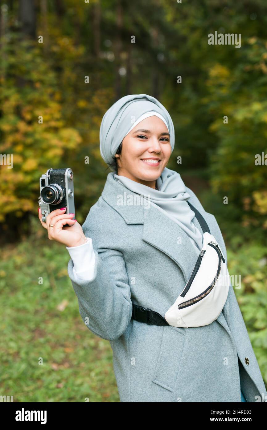 Young Arab Woman wearing hijab headscarf photographing with a ...