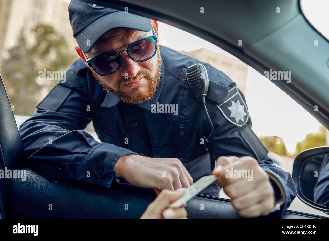 Police officer takes driver's license from driver Stock Photo