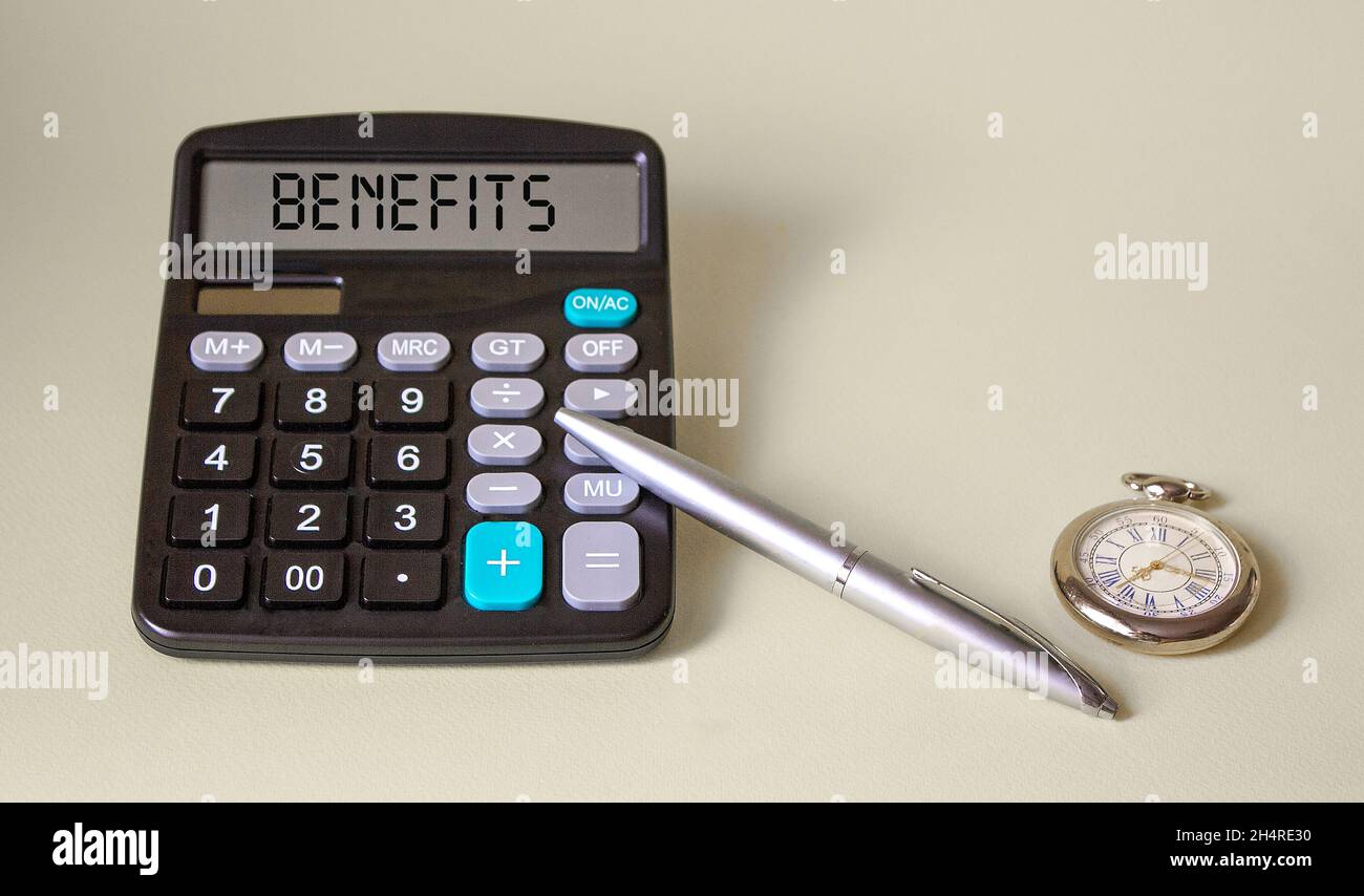 Word tax discount words written on a calculator with a clock, pen on a net background Stock Photo