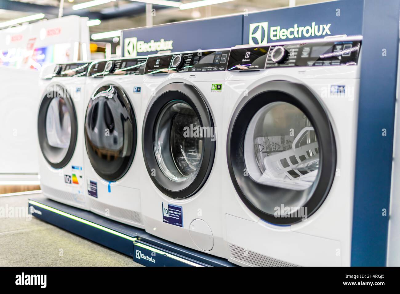 POZNAN, POL - AUG 18, 2021: Front-loader washing machines by Electrolux put up for sale in a household goods store Stock Photo