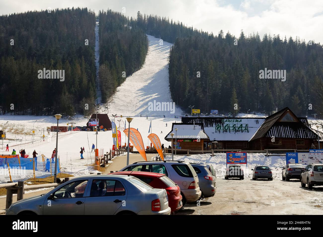 Zakopane, Poland - March 24, 2018: On the slope of the hill of the local name Nosal, among the forest areas there is a snowy ski slope. There is also Stock Photo