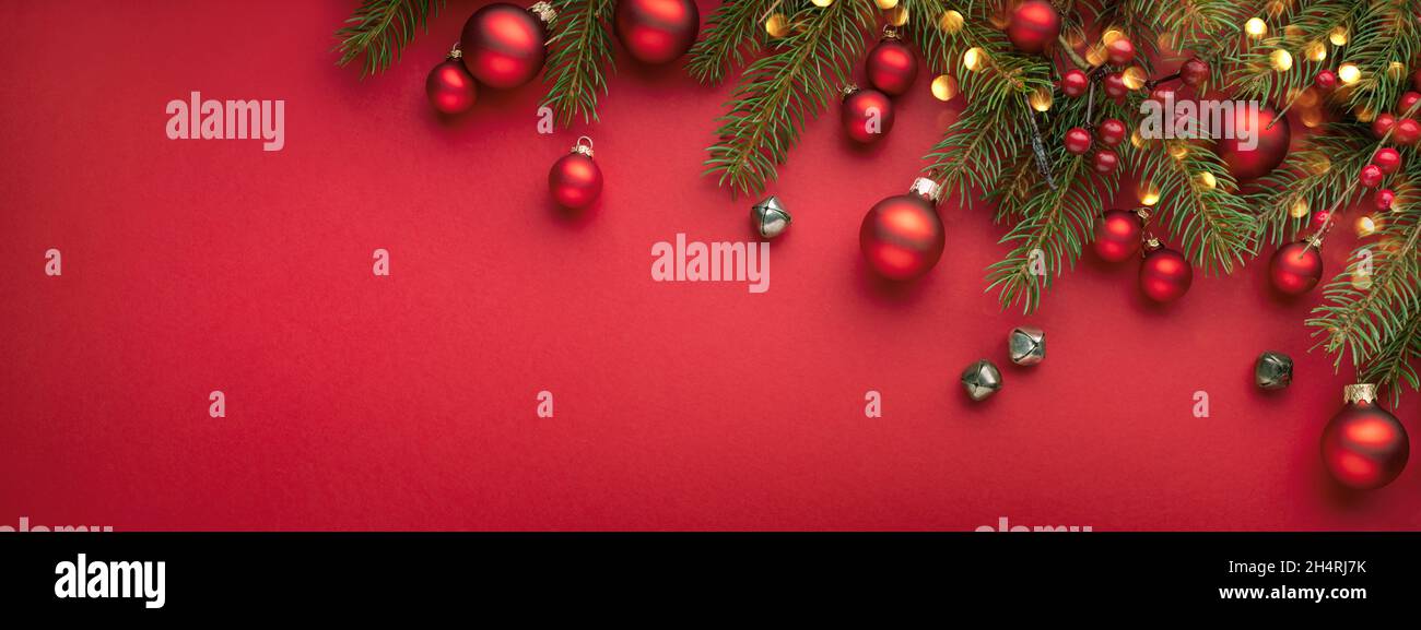 Red Christmas banner with fir branches, lights and decorations Stock ...