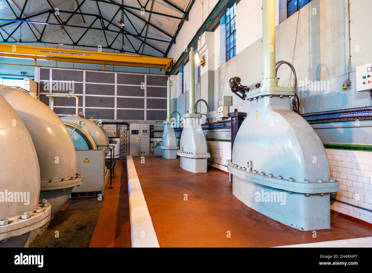 Pumps used to pump water from the river Thames (left) and blades (right) used to control the water flow in and and out of the South Dock at West India Dock Impounding Station, Canary Wharf, London, UK Stock Photo