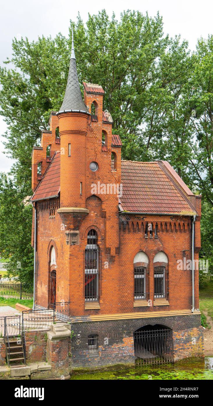 House of the caretaker of the bridge on the Pregolya River, Kaliningrad, Russia. The building is in the neo-gothic style. Stock Photo
