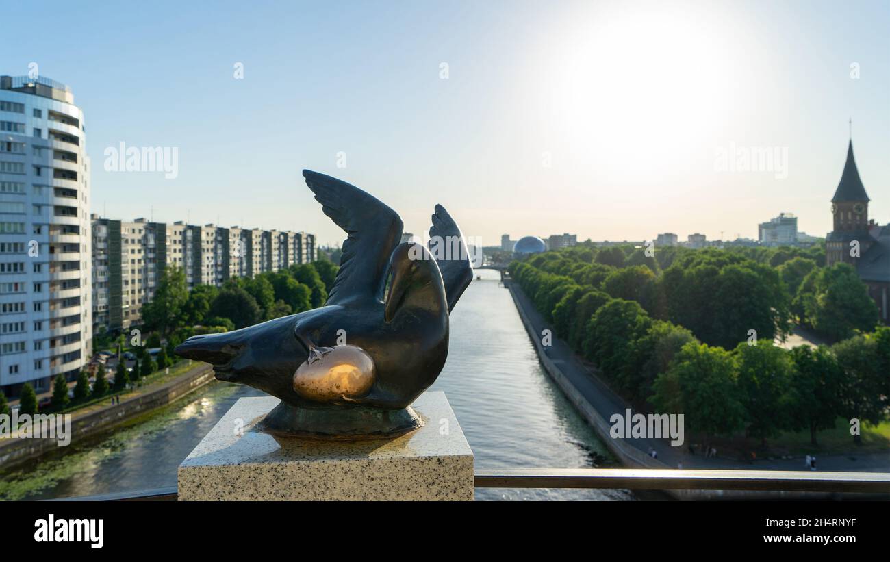 Sculpture The Bird of Happiness with a golden egg on the upper platform of the lighthouse in the Fishing village, Kaliningrad, Russia. Stock Photo