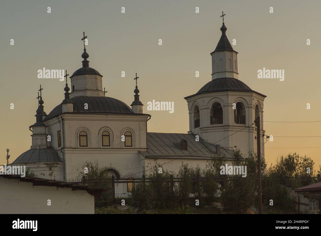 Snow-white ancient temple of Elijah the Prophet from the village of Ilyinka, Novokuznetsk district. Stock Photo