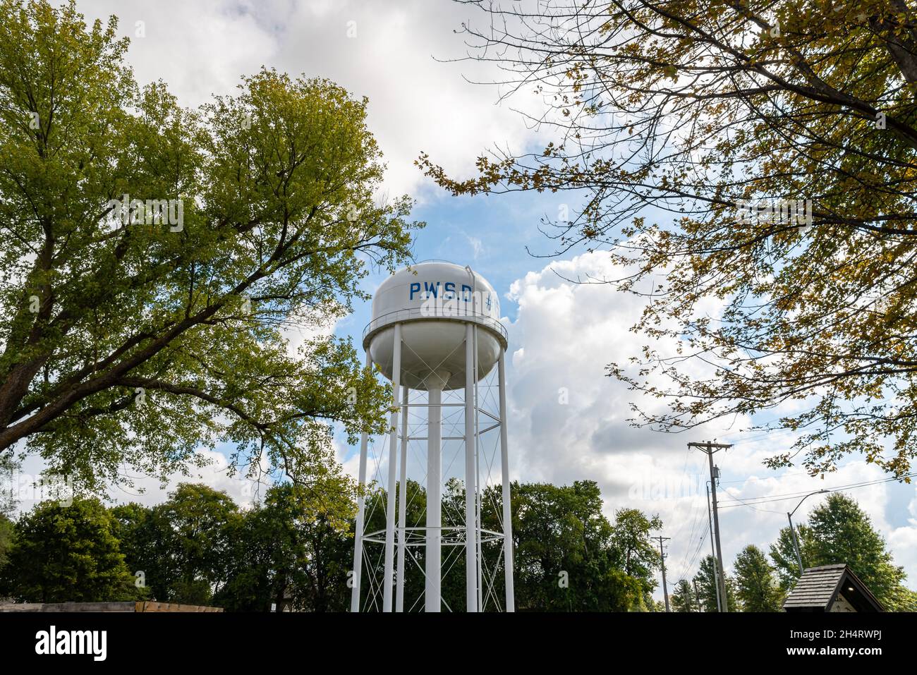A tall white municipal water tower marked with the letters PWSD in Lone