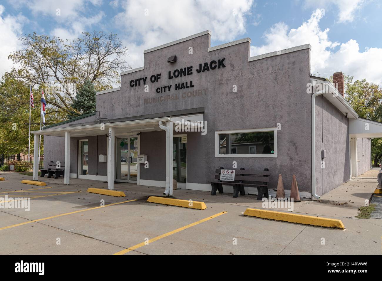 Exterior of the City of Lone Jack City Hall, a grey one story building with a western style false front and shed roof, Lone Jack, Missouri. Stock Photo