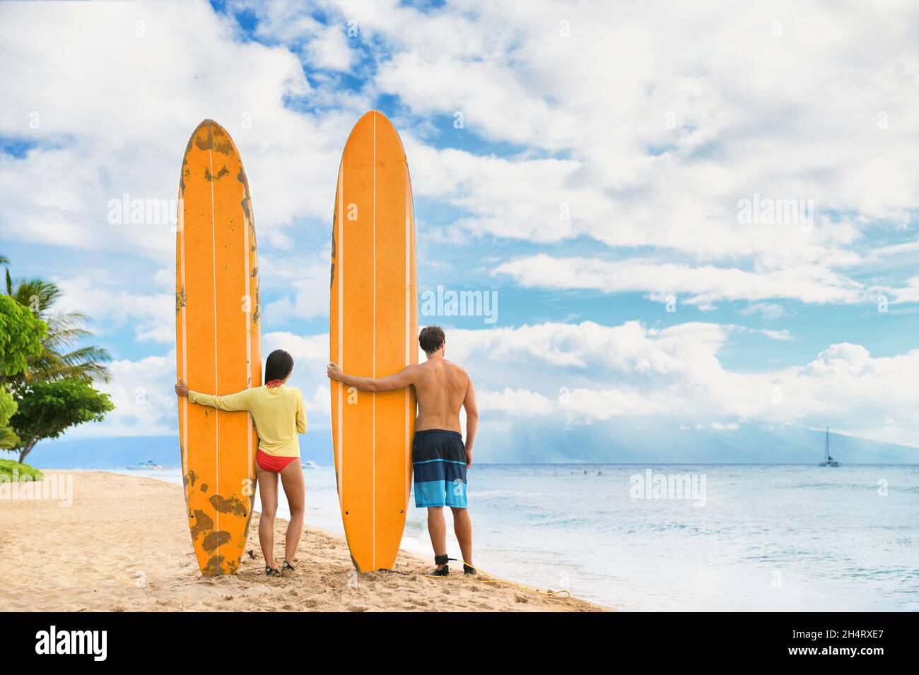 Beach surfers watching waves. Surfing lifestyle. Two people couple