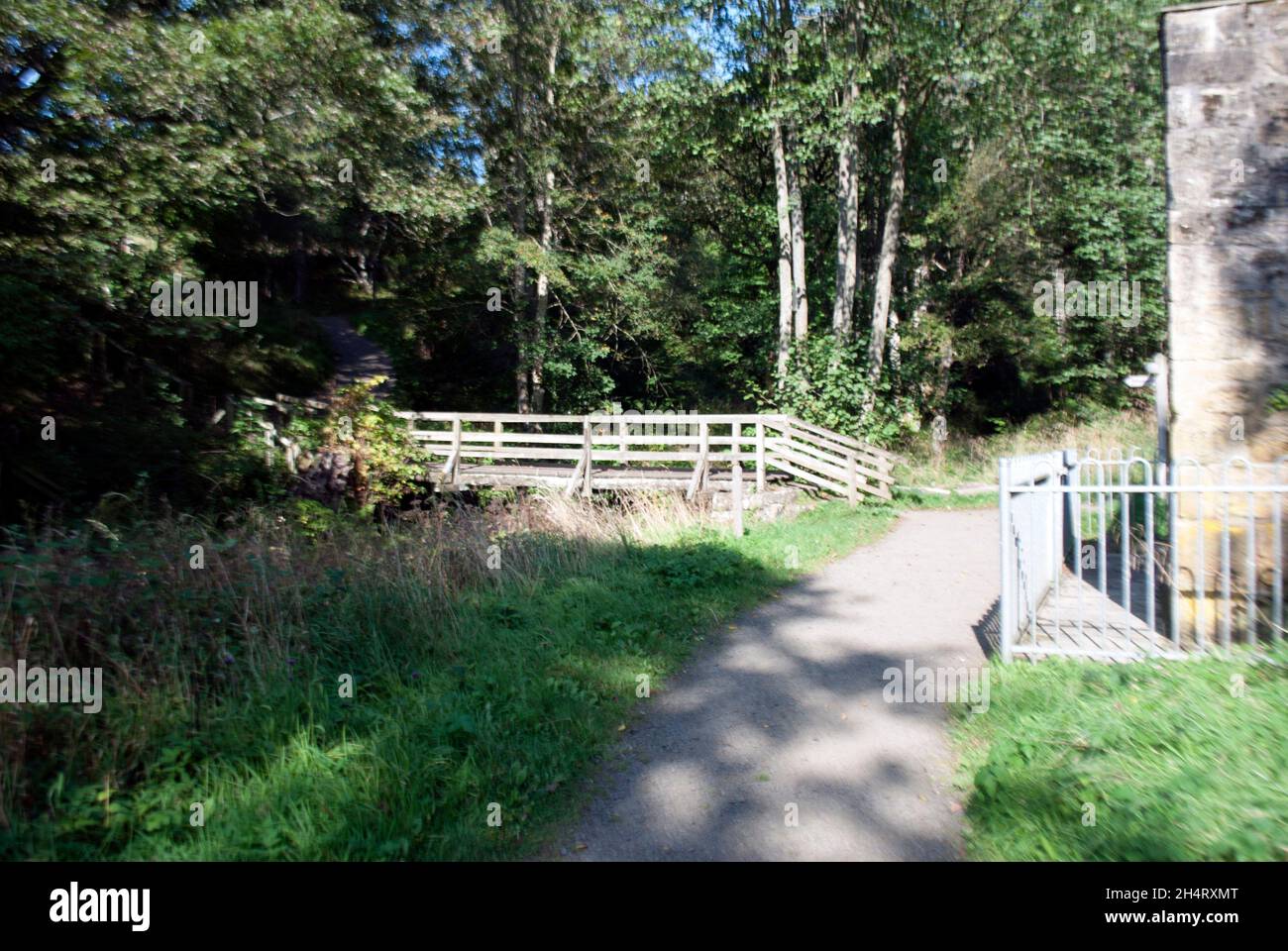 stream, footbridge near pumping station at Cragside, Rothbury ...
