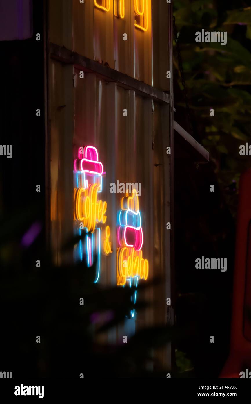 Hanging Neon sign taken aesthetically with tele lens. Stock Photo