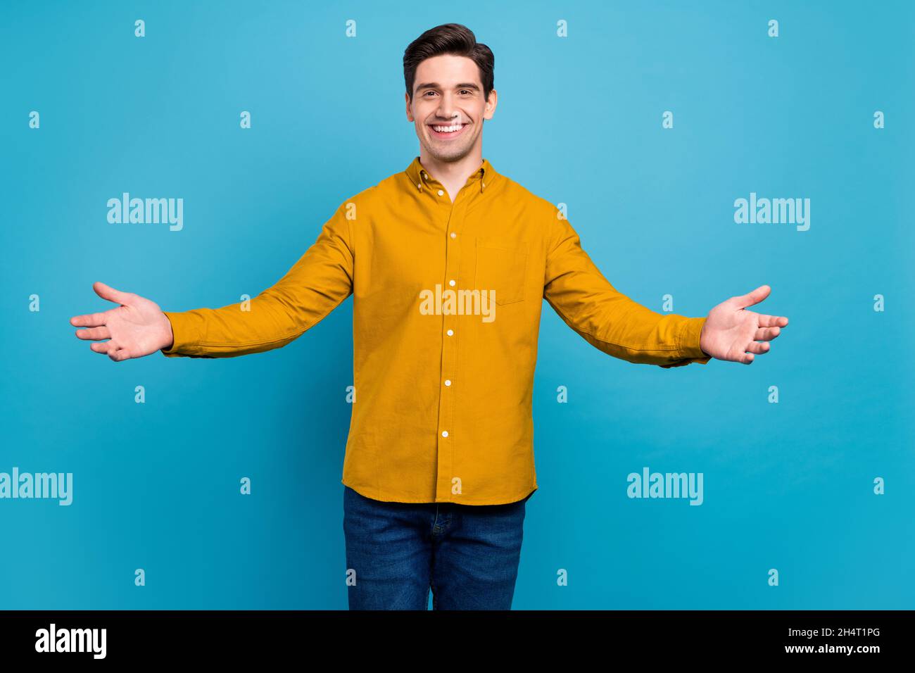 Photo of friendly hospitable guy invite embrace wear yellow shirt jeans