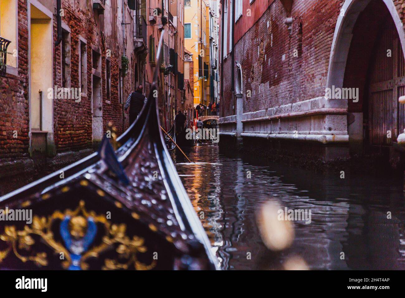 Traditional gondola on narrow canal on sunset in Venice, Italy Stock ...