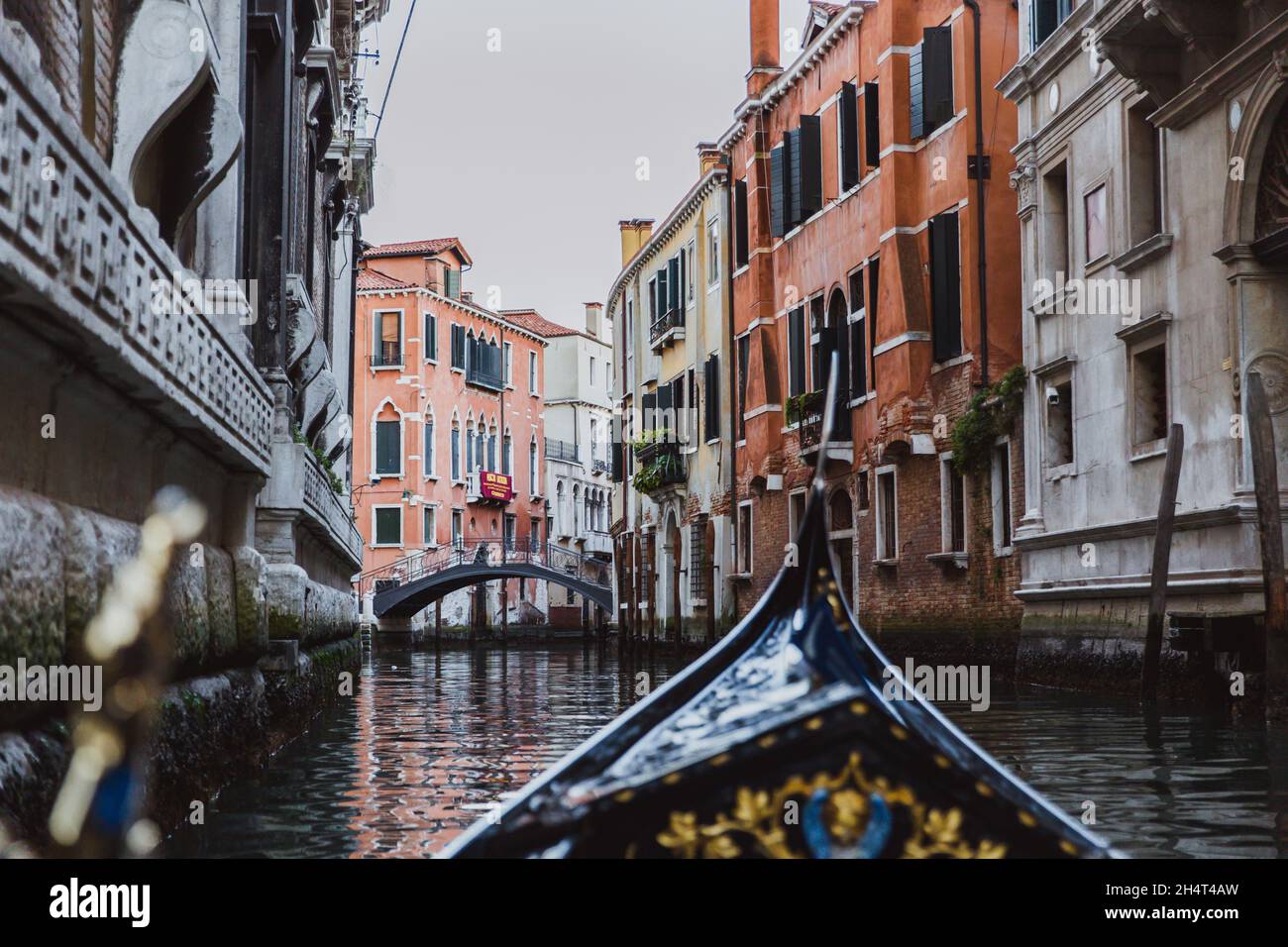 Traditional gondola on narrow canal on sunset in Venice, Italy Stock