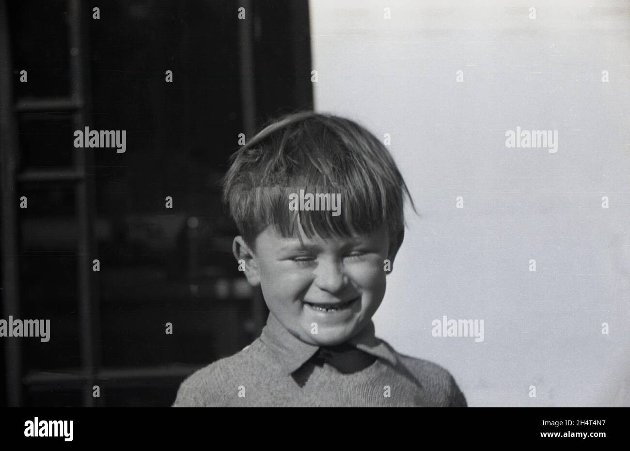 1960s, historical, a young schoolboy, outside, grining away, with a funny, happy, cheeky face, England, UK.. Stock Photo